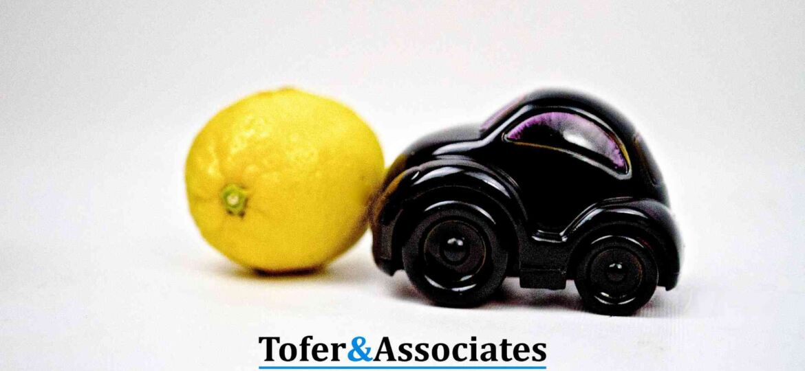 A lemon and a toy car in symbolizing a lemon car legal issue.