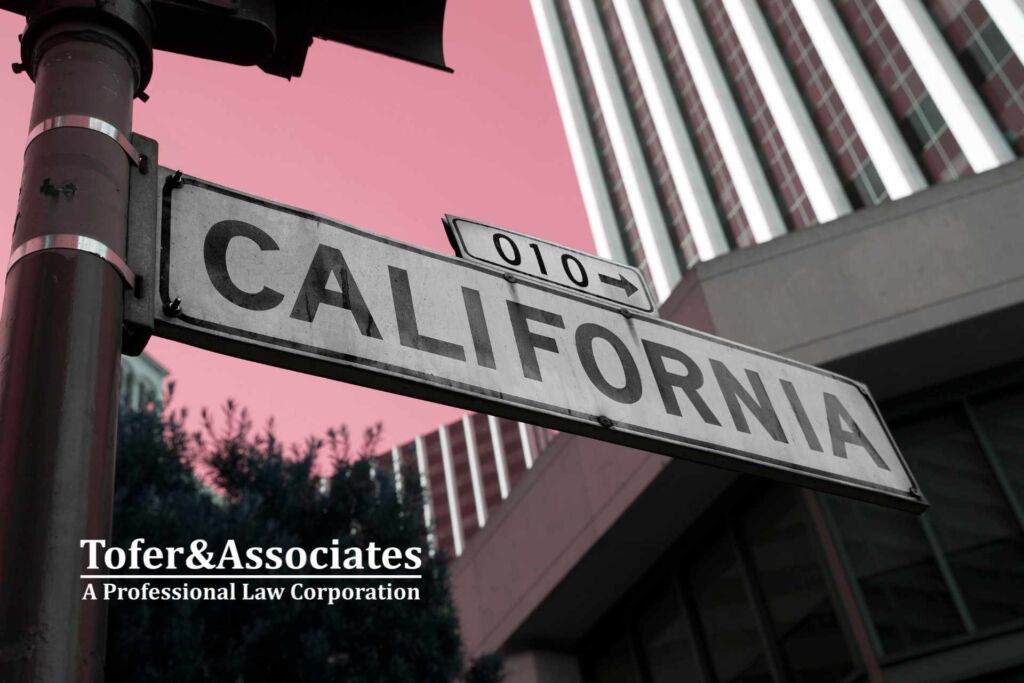 A sign in a California's street with the Tofer & Associates logo