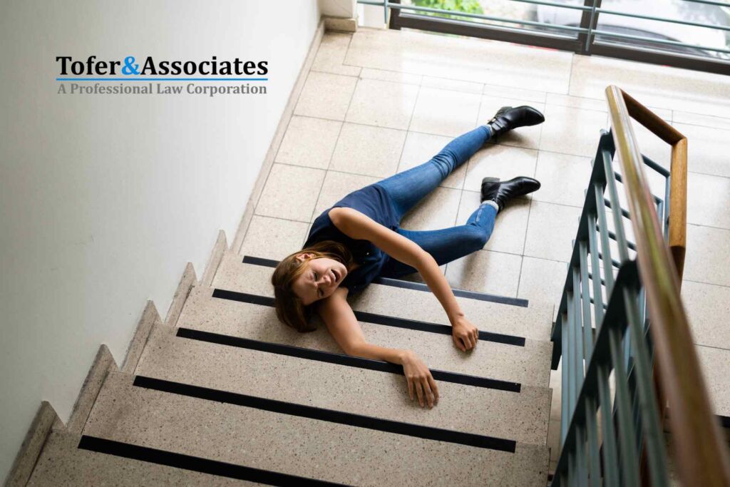 A woman on the floor after slipping and falling down the stairs